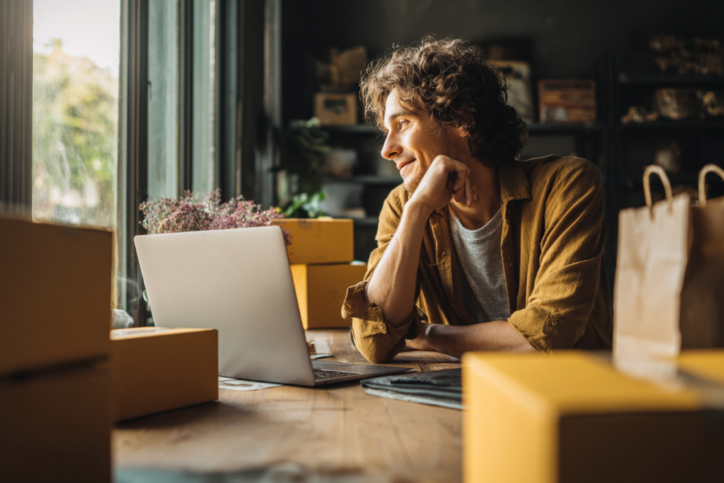 Woman writing notes - behind her is a shelf with parcels