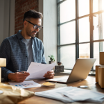 "Mann betrachtet Pakete mit der Marktplatz-Schnittstelle von Easybill Yatego auf dem Bildschirm, um Online-Geschäftsprozesse zu optimieren