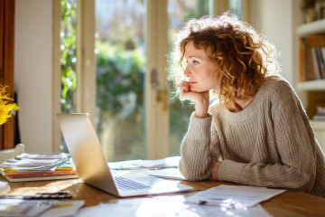 Frau verwendet Laptop zur digitalen Belegerfassung